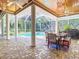 Expansive screened patio featuring brick flooring, ceiling fans, columns and an open view of the pool at 12010 Hardaman Pl, Tampa, FL 33618