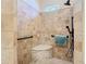 Shower with beautiful marble tile, a built-in seat, and modern fixtures at 12010 Hardaman Pl, Tampa, FL 33618