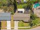 A top-down view of a home's roof, driveway, and yard, highlighting its layout and proximity to neighbors at 12520 Saint Charlotte Dr, Tampa, FL 33618