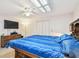 Bedroom showcasing wood furniture, a ceiling fan, and bed with blue striped bedding at 12520 Saint Charlotte Dr, Tampa, FL 33618