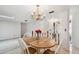 Well-lit dining space featuring a wooden table, chandelier, and a clear view of the home's entry, making it welcoming at 12520 Saint Charlotte Dr, Tampa, FL 33618