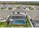 Aerial view showcasing the home, screened-in pool, and beautiful surroundings at 13176 Twin Bridges Dr, Riverview, FL 33579