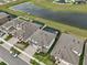 Aerial view of homes with a pond and lush green space, some with screened-in pools at 13176 Twin Bridges Dr, Riverview, FL 33579
