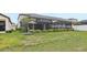 Spacious backyard showing the screened lanai with a beautiful lawn and landscaping at 13176 Twin Bridges Dr, Riverview, FL 33579