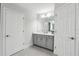 Neutral bathroom features a double vanity with granite countertops and a large mirror with modern lighting at 13176 Twin Bridges Dr, Riverview, FL 33579