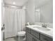 Full bath features gray vanity, bright lighting, and a shower with a shower curtain at 13176 Twin Bridges Dr, Riverview, FL 33579
