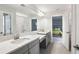 Modern bathroom boasts dual sinks with white quartz countertops and access to an adjacent bedroom at 13176 Twin Bridges Dr, Riverview, FL 33579