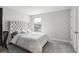 Bright bedroom featuring a tufted headboard, natural light, and plush carpeting, creating a cozy retreat at 13176 Twin Bridges Dr, Riverview, FL 33579