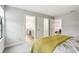 Bright bedroom featuring ensuite bathroom, walk-in closet, and access to a second-floor landing space at 13176 Twin Bridges Dr, Riverview, FL 33579
