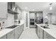 Modern kitchen features white cabinets, stainless steel appliances, and a large island at 13176 Twin Bridges Dr, Riverview, FL 33579
