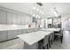 Bright kitchen with white cabinets, spacious island with seating, and stainless steel appliances at 13176 Twin Bridges Dr, Riverview, FL 33579