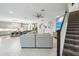 Bright, open-concept living room features a fireplace, tile flooring, and open access to kitchen at 13176 Twin Bridges Dr, Riverview, FL 33579