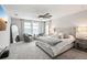 Relaxing bedroom with soft carpet, a cozy seating area, a large mirror, and ample natural light for comfort at 13176 Twin Bridges Dr, Riverview, FL 33579