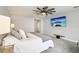 Cozy bedroom with soft carpet, a unique ceiling fan, and a wall-mounted TV creating a relaxing retreat at 13176 Twin Bridges Dr, Riverview, FL 33579