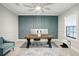 This home office space offers designer accent wall, modern furniture, and an abundance of natural light at 13176 Twin Bridges Dr, Riverview, FL 33579