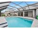 This stunning screened-in pool offers a sun shelf, a spacious deck, and beautiful backyard views at 13176 Twin Bridges Dr, Riverview, FL 33579