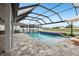 A lovely screened-in pool is surrounded by pavers and landscaping at 13176 Twin Bridges Dr, Riverview, FL 33579