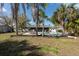 A relaxing backyard pool with slide, lounge chairs and palm trees on a sunny day at 13336 Moran Dr, Tampa, FL 33618