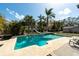 Backyard pool with slide surrounded by lush landscaping and ample deck space for entertaining at 13336 Moran Dr, Tampa, FL 33618