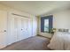 Bright bedroom with a large window, closet, and cozy carpeting at 1340 Powderpuff Dr # 806, Dunedin, FL 34698