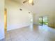 Bright living room with tile floors, vaulted ceiling, and sliding glass doors at 1340 Powderpuff Dr # 806, Dunedin, FL 34698