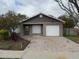 Cozy one-story home featuring a quaint front yard and a brick-paved driveway leading to an attached garage at 1525 Kestrel Way, Brandon, FL 33511