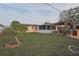 Large backyard featuring an outdoor patio with pergola, perfect for entertaining guests and enjoying outdoor living at 1623 Dartmouth Dr, Holiday, FL 34691