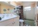 Bright bathroom featuring a shower with a curtain and a white vanity sink at 1623 Dartmouth Dr, Holiday, FL 34691