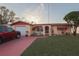 Charming single-story home with well-maintained lawn and vibrant landscaping at 1623 Dartmouth Dr, Holiday, FL 34691