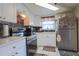 Efficient kitchen with modern appliances, white cabinets, and sleek countertops at 1623 Dartmouth Dr, Holiday, FL 34691