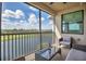 Spacious balcony with comfortable seating offering beautiful views of the adjacent pond at 17724 Gawthrop Dr # 402, Bradenton, FL 34211