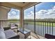 Enclosed balcony with outdoor seating that overlooks a picturesque water and green space at 17724 Gawthrop Dr # 402, Bradenton, FL 34211
