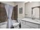 Well-lit bathroom featuring a shower-tub combo, stylish tiling, and a vanity with a white countertop at 17724 Gawthrop Dr # 402, Bradenton, FL 34211