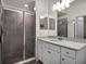 Well-lit bathroom featuring a vanity with a sink and a tiled walk-in shower at 17724 Gawthrop Dr # 402, Bradenton, FL 34211