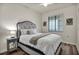 Bright bedroom featuring a comfortable queen bed, hardwood floors, and a large window at 17724 Gawthrop Dr # 402, Bradenton, FL 34211