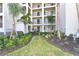 Exterior view of building with lush landscaping featuring palm trees and manicured lawn at 17724 Gawthrop Dr # 402, Bradenton, FL 34211