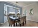 Bright dining room features a modern chandelier and a dining table with chairs and view at 17724 Gawthrop Dr # 402, Bradenton, FL 34211