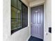 Apartment front entry featuring a dark gray door with a window and a black exterior at 17724 Gawthrop Dr # 402, Bradenton, FL 34211