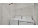 This laundry room includes a white washer and dryer with wire shelving for storage at 17724 Gawthrop Dr # 402, Bradenton, FL 34211