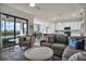 Well-lit living room with an open floor plan, connecting to dining and kitchen areas at 17724 Gawthrop Dr # 402, Bradenton, FL 34211