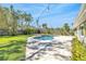 Serene backyard with swimming pool, perfect for relaxing and entertaining surrounded by lush greenery at 1842 Oklahoma Ne Ave, St Petersburg, FL 33703