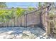 Cozy backyard stone patio with a wooden pergola featuring a table and privacy screen at 1842 Oklahoma Ne Ave, St Petersburg, FL 33703