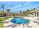 Private in-ground swimming pool surrounded by a spacious patio, lush lawn and mature landscaping at 1842 Oklahoma Ne Ave, St Petersburg, FL 33703