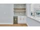 Cozy bar area featuring custom shelving and a built-in wine cooler for the discerning homeowner at 1842 Oklahoma Ne Ave, St Petersburg, FL 33703