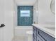 Charming bathroom with blue accent wall, hexagon tiled floors, and gold hardware at 1842 Oklahoma Ne Ave, St Petersburg, FL 33703