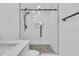 Bright bathroom boasting sleek, glass-enclosed shower with contemporary fixtures and a geometric-tiled floor at 1842 Oklahoma Ne Ave, St Petersburg, FL 33703