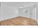 Bright bedroom with hardwood floors, a ceiling fan, and natural light. Ready for staging at 1842 Oklahoma Ne Ave, St Petersburg, FL 33703