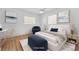 This virtually staged bedroom features neutral decor, artwork, and an accent chair at 1842 Oklahoma Ne Ave, St Petersburg, FL 33703