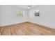 A bright bedroom featuring two windows and wood flooring at 1842 Oklahoma Ne Ave, St Petersburg, FL 33703