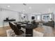 Dining room featuring a dark table, six chairs, and an accent wall, with an open layout to a living area at 1842 Oklahoma Ne Ave, St Petersburg, FL 33703
